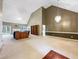 Expansive living room featuring vaulted ceilings, a bookcase, plush carpets, and leather seating at 9135 Woodhaven Way, Mcdonough, GA 30253