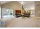 Bright living room featuring vaulted ceilings, plush carpets, comfortable leather sofas, and ample natural light at 9135 Woodhaven Way, Mcdonough, GA 30253