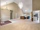 Open-concept living area with vaulted ceilings, plush carpet, and access to the kitchen and other rooms at 9135 Woodhaven Way, Mcdonough, GA 30253