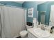 Bathroom features a shower with patterned curtain, a toilet, and a vanity with sink at 31 Wyngate Ct, Dallas, GA 30157