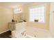 Bright bathroom features a soaking tub with jets and a large window at 31 Wyngate Ct, Dallas, GA 30157