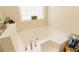 Bright bathroom featuring a large soaking tub and lots of natural light at 31 Wyngate Ct, Dallas, GA 30157