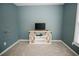 A cozy carpeted room with light blue walls and modern storage and tv console at 31 Wyngate Ct, Dallas, GA 30157