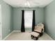 Calming bedroom with soft colors, chair, ottoman, and window with black curtains at 31 Wyngate Ct, Dallas, GA 30157