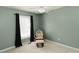 Cozy bedroom featuring a chair and ottoman near a window with black curtains at 31 Wyngate Ct, Dallas, GA 30157
