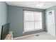 A brightly lit bedroom featuring freshly painted walls, a ceiling fan, and a spacious window at 31 Wyngate Ct, Dallas, GA 30157