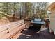 Spacious deck with built-in bench seating and a stainless steel BBQ grill, perfect for outdoor entertaining at 31 Wyngate Ct, Dallas, GA 30157