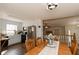 Open dining area with wood table, kitchen access, and staircase leading upstairs offers great flow at 31 Wyngate Ct, Dallas, GA 30157