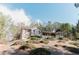 Scenic exterior view showcasing the home's hillside placement and large lot with mature trees at 31 Wyngate Ct, Dallas, GA 30157