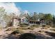 Scenic exterior view showcasing the home's hillside placement and large lot with mature trees at 31 Wyngate Ct, Dallas, GA 30157