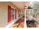 Inviting front porch with wood flooring, red shutters, and a gazebo perfect for outdoor relaxation at 31 Wyngate Ct, Dallas, GA 30157