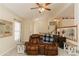 Comfortable living room with a ceiling fan, plush seating, and view of the staircase at 31 Wyngate Ct, Dallas, GA 30157
