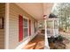 Charming covered porch with red shutters and a gazebo with a bench at 31 Wyngate Ct, Dallas, GA 30157
