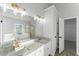 Well-lit bathroom with dual sinks, granite countertops, and gold fixtures at 4275 Azalea Walk, Ellenwood, GA 30294