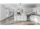 Open-concept kitchen with white cabinets, granite countertops, and a seamless flow to the living area at 4275 Azalea Walk, Ellenwood, GA 30294