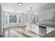Bright kitchen with stainless steel appliances, white cabinets, and large windows at 4275 Azalea Walk, Ellenwood, GA 30294