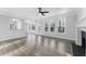 Spacious living room with fireplace, large windows, and hardwood floors at 4275 Azalea Walk, Ellenwood, GA 30294