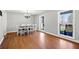 Open dining room with hardwood floors, bright windows, and a chandelier above the table at 4885 Pisgah Rd, Cumming, GA 30028