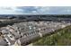 An aerial view of a dense townhome community showcases the neighborhood's layout and proximity to surrounding areas at 5316 Radford Loop, Fairburn, GA 30213