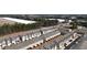 Aerial view of a residential neighborhood with neat rows of townhomes and mature trees at 5316 Radford Loop, Fairburn, GA 30213