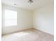 Bright bedroom with neutral walls, blinds and soft carpet, offering a serene space for rest and relaxation at 5316 Radford Loop, Fairburn, GA 30213