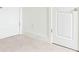 Carpeted room featuring base molding, white walls and doors at 5316 Radford Loop, Fairburn, GA 30213