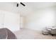 Spacious carpeted bedroom with white walls and a plush silver accent chair at 5316 Radford Loop, Fairburn, GA 30213