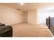 Spacious bonus room featuring plush carpeting, neutral walls and abundant natural light, ready for personalization at 5316 Radford Loop, Fairburn, GA 30213