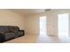 Cozy bonus room with neutral carpeting, gray recliner sofa and plenty of natural light at 5316 Radford Loop, Fairburn, GA 30213