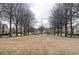 Expansive community green space with mature trees, landscaping, and walking paths create a serene environment at 5316 Radford Loop, Fairburn, GA 30213