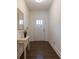 View of the entryway with dark floors, white walls, and decorative furniture at 5316 Radford Loop, Fairburn, GA 30213