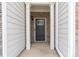 Front door view with white columns, brick, and black front door with glass at 5316 Radford Loop, Fairburn, GA 30213