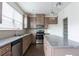 Modern kitchen featuring stainless appliances, granite countertops, and wood cabinets at 5316 Radford Loop, Fairburn, GA 30213