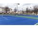 Well-maintained blue and green tennis courts with lighting, surrounded by townhomes, offer an active lifestyle at 5316 Radford Loop, Fairburn, GA 30213