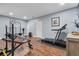 Basement with finished flooring, a TV, door, and workout equipment at 644 Herring Rd, Grayson, GA 30017