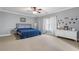 Spacious bedroom with neutral carpet and decor, featuring a dresser and artwork at 644 Herring Rd, Grayson, GA 30017