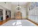 Dining room with hardwood floors, chandelier, and large windows, providing ample natural light at 644 Herring Rd, Grayson, GA 30017