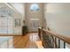 Two-story foyer with hardwood floors, a staircase, and a large window bringing in natural light at 644 Herring Rd, Grayson, GA 30017