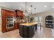 Spacious kitchen with custom cabinets, granite counters, an island, and stainless steel appliances at 644 Herring Rd, Grayson, GA 30017