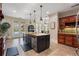Modern kitchen with a central island, stainless steel appliances, and access to the pool area at 644 Herring Rd, Grayson, GA 30017