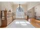 Bright living room with high ceilings, a large window, chandelier, and hardwood floors at 644 Herring Rd, Grayson, GA 30017