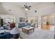 Open-concept living room with natural light, a view of the dining room, and hardwood floors at 644 Herring Rd, Grayson, GA 30017