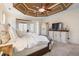 Comfortable main bedroom with a unique tray ceiling, plush bedding, and neutral tones at 644 Herring Rd, Grayson, GA 30017