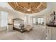 Serene main bedroom suite with a unique trey ceiling, sitting area, neutral tones, and ample natural light at 644 Herring Rd, Grayson, GA 30017
