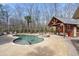 Backyard swimming pool with an adjacent cabana and views of the surrounding wooded area at 644 Herring Rd, Grayson, GA 30017