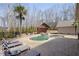 Backyard pool and spa with a cabana, surrounded by a privacy fence and mature trees at 644 Herring Rd, Grayson, GA 30017