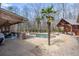 Outdoor living at its finest with a sparkling pool, spa, covered patio, and outdoor kitchen surrounded by mature trees at 644 Herring Rd, Grayson, GA 30017