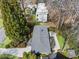 Aerial view of the property showcasing the roof, backyard patio, landscaping, and surrounding greenery at 2711 Winding Ne Ln, Brookhaven, GA 30319