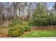 Landscaped backyard with manicured lawn, bushes, and a wooden fence creating a private outdoor space at 2711 Winding Ne Ln, Brookhaven, GA 30319