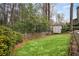 Serene backyard featuring a storage shed, green grass, and a peaceful, private setting at 2711 Winding Ne Ln, Brookhaven, GA 30319